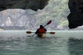 Couple exploring cave on kayak and taking photograps in the boat. Ha Long Bay, Vietnam, Cat Ba Island Royalty Free Stock Photo