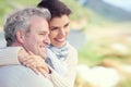 Couple, face and smile outdoor with hug for romance, love and relationship in nature with comfort. Mature, man and woman Royalty Free Stock Photo