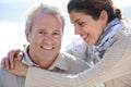 Couple, face and smile outdoor with hug for romance, love and relationship in nature with peace. Mature, man and woman Royalty Free Stock Photo