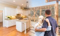 Couple Facing Construction Framing Gradating To Completed Custom Kitchen