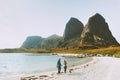 Couple family with baby traveling together walk on beach in Norway Royalty Free Stock Photo