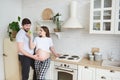 Couple family embrace standing in the kitchen