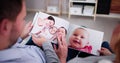 Couple Family Looking Photo Album Royalty Free Stock Photo