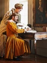 Couple, feather and writing a letter, royal and relax in home for history in noble palace. People, quill and bonding or