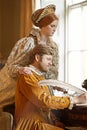 Couple, feather and writing a letter, together and relax in home for history in noble palace. People, love and bonding