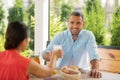 Couple feeling truly relieved enjoying breakfast outside