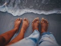 Couple feet, beach sand and water at ocean waves, nature and summer travel for vacation, honeymoon date and tropical Royalty Free Stock Photo