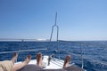 View on man and woman legs laying on yacht with blue sea. Summer holidays concept Royalty Free Stock Photo