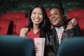 A couple of female audiences watch funny cinema at a movie theater. Royalty Free Stock Photo