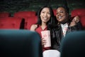 A couple of female audiences watch funny cinema at a movie theater. Royalty Free Stock Photo