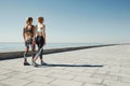 Couple female running exercising jogging happy on waterfront
