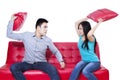 Couple fight on red sofa - isolated Royalty Free Stock Photo