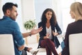 Couple fighting and arguing in therapy session with patient therapist helping inside office. Female marriage counsellor Royalty Free Stock Photo