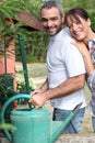 Couple filling up watering can