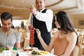 Couple, fine dining and waiter serving food or sausage kebab on skewer or restaurant, anniversary or nutrition. Man Royalty Free Stock Photo