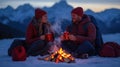 Couple by fire in snowy mountains Royalty Free Stock Photo