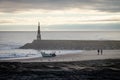 Couple, Fisherman and Boat near Beacon at the Ocean Royalty Free Stock Photo