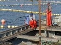 Couple of fishermen preparing fishing line