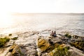 Couple fishing in the ocean during sunset