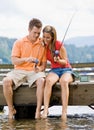 Couple fishing on pier Royalty Free Stock Photo