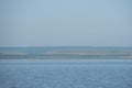 Couple fishing with a fishing rod from a boat on a clear Sunny summer day on the lake