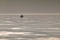 Couple fishing on a small boat on a foggy day