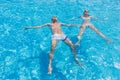 Couple Floating on Backs in Resort Swimming Pool