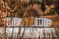 Couple of floating grey cabins on the lake