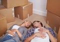 Couple, floor and moving or boxes for new home packing or real estate property to relax in marriage and apartment. Man Royalty Free Stock Photo