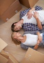 Couple, floor and moving boxes or rest from packing or real estate property for bonding, marriage or apartment. Man Royalty Free Stock Photo