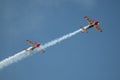 Couple of flying aircraft against a blue sky during an airshow