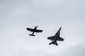 Couple of flying aircraft against a cloudy sky during an airshow