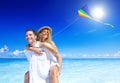 Couple Flying a Kite on the Beach Vacations Concept Royalty Free Stock Photo