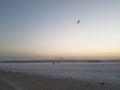 Couple flying kite in romantic sunset setting