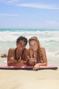 Couple on a foam surfboard at beach Royalty Free Stock Photo