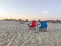 Couple of folding chairs on sandy beach in evening Royalty Free Stock Photo