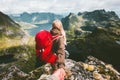 Couple follow holding hands on cliff mountain in Norway
