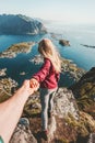 Couple follow holding hands traveling lifestyle on cliff