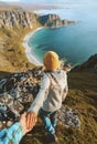 Couple follow me holding hands hiking in mountains above ocean beach friends traveling together in Norway