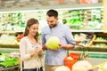 Couple with food basket shopping at grocery store Royalty Free Stock Photo