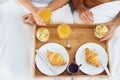 Couple, food and breakfast in bed for morning, wakeup or meat and snack together in relax at home. Top view of man and Royalty Free Stock Photo