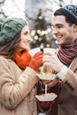 Couple with food and drink on Christmas market Royalty Free Stock Photo