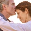 Couple, forehead kiss and hug with love, respect or happiness on holiday in romance. Mature, man and woman embrace Royalty Free Stock Photo