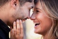 Couple, forehead touch and laugh together with happiness, comic moment or romance outdoor for date. Man, woman and funny