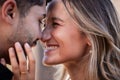Couple, forehead touch and laughing together with happiness, comic moment or romance outdoor for date. Man, woman and