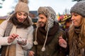 Couple and Friend drink Mulled Wine on the Christmas Market Royalty Free Stock Photo
