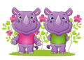 The couple of friendly rhino in the welcoming posing in the garden full of the flowers Royalty Free Stock Photo