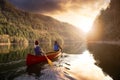 Couple friends canoeing on a wooden canoe