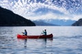 Couple friends canoeing on a wooden canoe Royalty Free Stock Photo