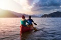 Couple friends canoeing on a wooden canoe Royalty Free Stock Photo